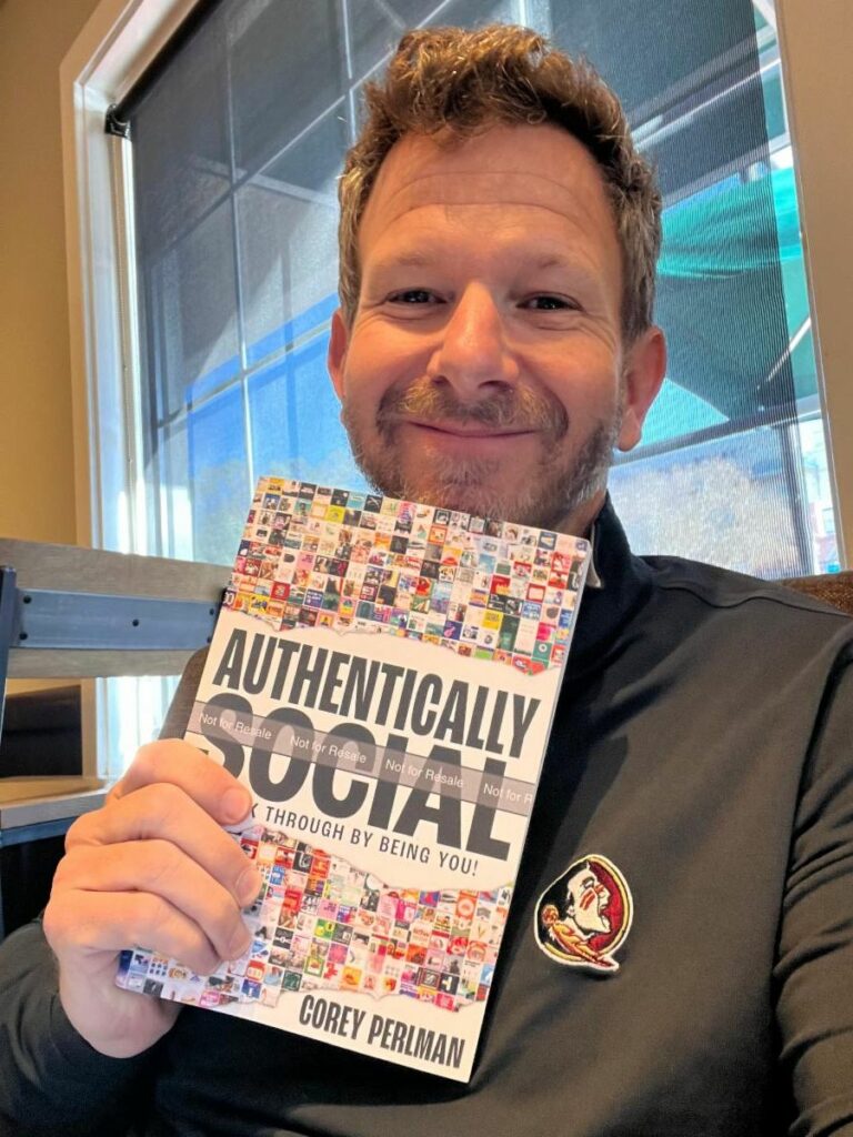 Author, Corey Perlman holding an advanced copy of his latest book, Authentically Social
